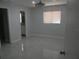 Neutral bedroom with modern ceiling fan, window and ensuite bathroom at 361 Yorkshire St, Port Charlotte, FL 33954
