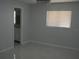 Neutral bedroom with modern ceiling fan, window and ensuite bathroom at 361 Yorkshire St, Port Charlotte, FL 33954