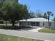 Charming single-story home with a lush lawn and a metal roof, offering great curb appeal at 361 Yorkshire St, Port Charlotte, FL 33954