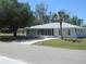 Charming single-story home with a lush lawn and a metal roof, offering great curb appeal at 361 Yorkshire St, Port Charlotte, FL 33954