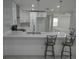 Bright kitchen with stainless steel appliances, white cabinets, and a bar counter with elegant seating at 361 Yorkshire St, Port Charlotte, FL 33954