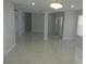 Spacious open concept living area with gray tile floors and neutral paint, leading to other rooms at 361 Yorkshire St, Port Charlotte, FL 33954