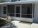 Enclosed porch with white frame and gray door leading to the building's entrance at 361 Yorkshire St, Port Charlotte, FL 33954