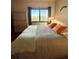 Cozy bedroom with water view, dresser, and comfortable bed with orange pillows at 3630 Gulf Of Mexico Dr # 304, Longboat Key, FL 34228