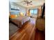 Cozy bedroom with hardwood floors, a comfortable queen-sized bed, and a view of the water at 3630 Gulf Of Mexico Dr # 304, Longboat Key, FL 34228