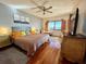 Bright bedroom with wooden floors, ceiling fan, waterfront view, and comfortable seating at 3630 Gulf Of Mexico Dr # 304, Longboat Key, FL 34228