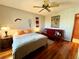 Bedroom featuring wood floors, ceiling fan, and comfortable seating area at 3630 Gulf Of Mexico Dr # 304, Longboat Key, FL 34228
