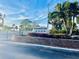 Elegant community sign for Buttonwood Cove with vibrant flowers and well-maintained landscaping at 3630 Gulf Of Mexico Dr # 304, Longboat Key, FL 34228