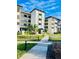 Well-maintained condo building with manicured landscaping and inviting walkways at 3630 Gulf Of Mexico Dr # 304, Longboat Key, FL 34228