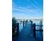 Scenic view of a private wooden dock extending into calm waters, perfect for boating enthusiasts at 3630 Gulf Of Mexico Dr # 304, Longboat Key, FL 34228