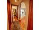Hallway with wood floors leading to living room with waterfront views through sliding doors at 3630 Gulf Of Mexico Dr # 304, Longboat Key, FL 34228