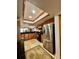 Kitchen with wood cabinets, granite countertops, stainless steel refrigerator, and breakfast bar access at 3630 Gulf Of Mexico Dr # 304, Longboat Key, FL 34228