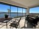 Enjoy serene water views from this screened lanai with comfortable seating and a dining table at 3630 Gulf Of Mexico Dr # 304, Longboat Key, FL 34228