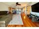Open concept living room with hardwood floors, a large sectional sofa, and an arched doorway to the kitchen at 3630 Gulf Of Mexico Dr # 304, Longboat Key, FL 34228
