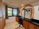 Home office area featuring built-in cabinets, granite countertop, and views of the outside at 3630 Gulf Of Mexico Dr # 304, Longboat Key, FL 34228