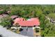 Aerial view of the home with a red tile roof surrounded by lush greenery at 3804 Sun Eagle Ln, Bradenton, FL 34210