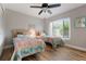Bright bedroom featuring twin beds, wood floors, and a ceiling fan at 3804 Sun Eagle Ln, Bradenton, FL 34210