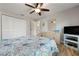 Bright bedroom featuring a ceiling fan, closet, dresser, and coastal-themed bedding at 3804 Sun Eagle Ln, Bradenton, FL 34210
