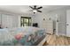 Bright bedroom with white dresser, coat rack, and view of outdoors from the sliding glass door at 3804 Sun Eagle Ln, Bradenton, FL 34210