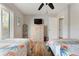 Bright bedroom featuring twin beds, wood floors, and a dresser at 3804 Sun Eagle Ln, Bradenton, FL 34210