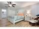 Bright bedroom with light colored floors, adjoining bathroom, and a ceiling fan at 3804 Sun Eagle Ln, Bradenton, FL 34210