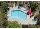 Aerial view of the community pool and hot tub surrounded by lush greenery at 3804 Sun Eagle Ln, Bradenton, FL 34210