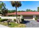 Charming single-story home with a red tile roof, lush landscaping, and an attached two-car garage at 3804 Sun Eagle Ln, Bradenton, FL 34210