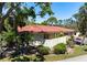 Low angle exterior view with red tile roof, landscaping, and a driveway leading to the garage at 3804 Sun Eagle Ln, Bradenton, FL 34210