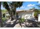 Rear exterior view of a home with a red tile roof and a small patio area at 3804 Sun Eagle Ln, Bradenton, FL 34210