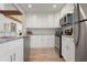 Bright kitchen featuring white cabinets, stainless steel appliances, and a subway tile backsplash at 3804 Sun Eagle Ln, Bradenton, FL 34210