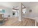 Open concept living space with wood-look flooring and modern decor, flowing into the kitchen at 3804 Sun Eagle Ln, Bradenton, FL 34210
