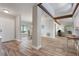 Open concept living space with wood-look flooring and modern decor, flowing into the kitchen at 3804 Sun Eagle Ln, Bradenton, FL 34210