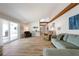 Spacious living room with wood-look tile flooring, a vaulted ceiling and sliding door access to the patio at 3804 Sun Eagle Ln, Bradenton, FL 34210