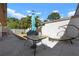 Outdoor patio with dining table, lounge chair, and blue umbrella at 3804 Sun Eagle Ln, Bradenton, FL 34210