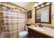 Bathroom featuring a vanity with a decorative mirror, and a bathtub with a striped shower curtain at 3865 N Cranberry Blvd, North Port, FL 34286
