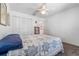 Bright bedroom with a ceiling fan, closet, and a comfortable-looking bed with a floral star pattern bedspread at 3865 N Cranberry Blvd, North Port, FL 34286