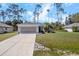 Charming single-story home with a well-maintained front yard, driveway, and mature landscaping at 3865 N Cranberry Blvd, North Port, FL 34286