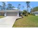 Charming single-story home featuring a well-manicured lawn, neutral paint, and an attached two-car garage at 3865 N Cranberry Blvd, North Port, FL 34286