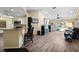Bright, open living room with modern flooring, breakfast bar and sliding glass doors to enjoy Florida living at 3865 N Cranberry Blvd, North Port, FL 34286