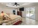 Bedroom with tiled floors, backyard access, and a walk-in closet at 3865 N Cranberry Blvd, North Port, FL 34286