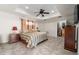 Spacious main bedroom featuring tiled floors, ceiling fan, and walk-in closet at 3865 N Cranberry Blvd, North Port, FL 34286