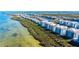 Picturesque aerial view of waterfront condos surrounded by mangrove islands, with serene blue waters in the background at 388 Aruba Cir # 201, Bradenton, FL 34209