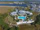 Aerial view of community clubhouse with lake and gorgeous landscaping with lake and surrounding neighborhood at 388 Aruba Cir # 201, Bradenton, FL 34209