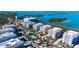 Breathtaking aerial view of coastal condos featuring a community pool, clubhouse, and scenic waterfront location at 388 Aruba Cir # 201, Bradenton, FL 34209