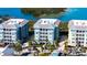 Stunning aerial view of resort condos, showcasing lush landscaping, water views, and coastal architecture at 388 Aruba Cir # 201, Bradenton, FL 34209