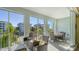 Relaxing screened balcony with comfortable seating and views of the surrounding community and lush landscaping at 388 Aruba Cir # 201, Bradenton, FL 34209