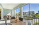 Relaxing screened in balcony with comfortable seating and views of the surrounding community and lush landscaping at 388 Aruba Cir # 201, Bradenton, FL 34209