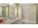 Bright bathroom featuring white marble tile, a white vanity with light granite counters, and modern fixtures at 388 Aruba Cir # 201, Bradenton, FL 34209
