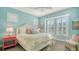 Charming bedroom with a large window, plantation shutters, and a cozy bed with decorative pillows at 388 Aruba Cir # 201, Bradenton, FL 34209