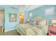 Stylish bedroom featuring an en-suite bathroom, coastal decor, and a comfortable bed at 388 Aruba Cir # 201, Bradenton, FL 34209